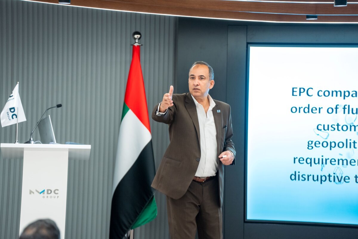 NMDC Group: Presenting beside the UAE flag